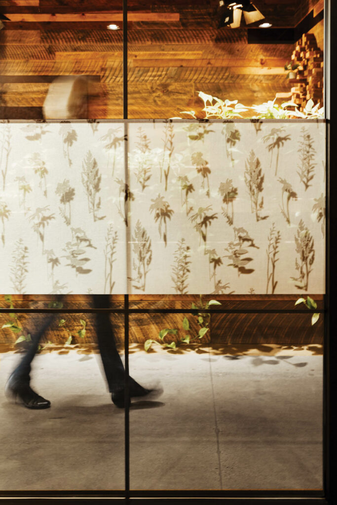 a person walks behind design pool's wallcovering