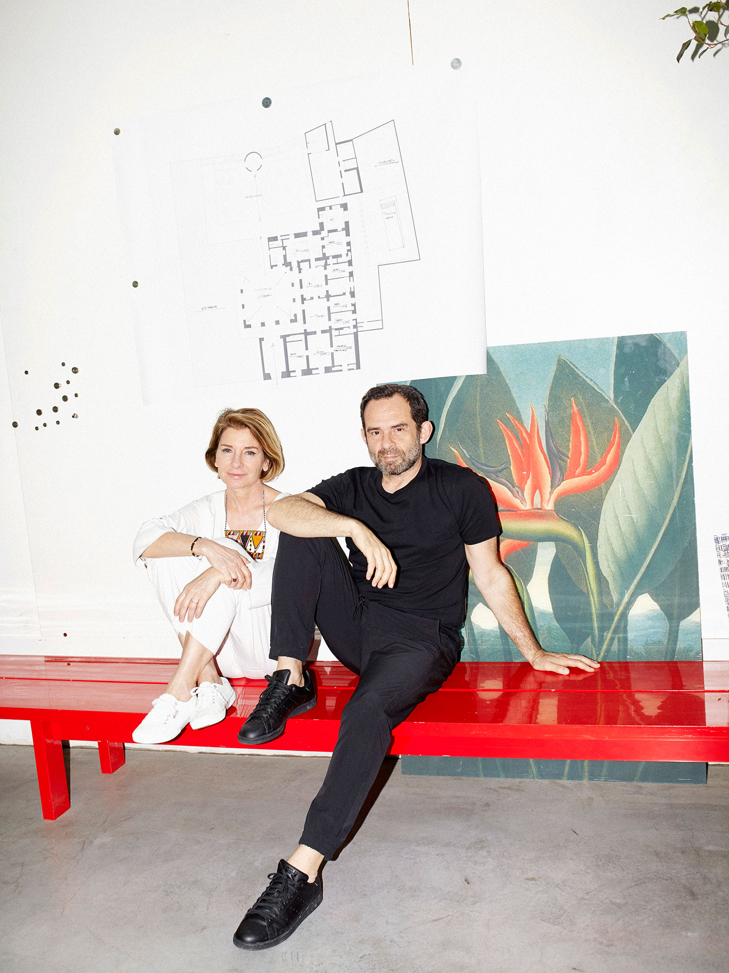 Roberto Palomba and Ludovica Serafina on a red bench