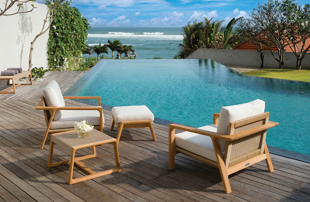 white lounge chairs on a pool deck