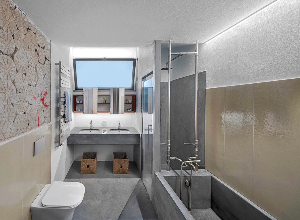 a gray bathroom in the main bedroom