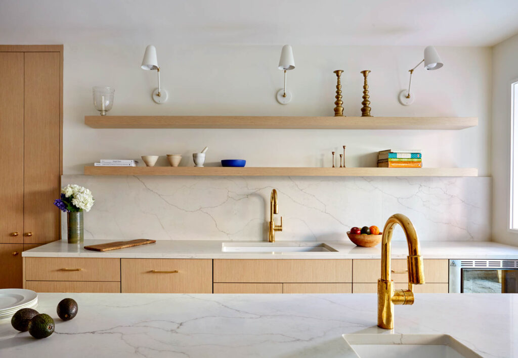 kitchen with wooden floating shelves, cabinets and bronze faucet