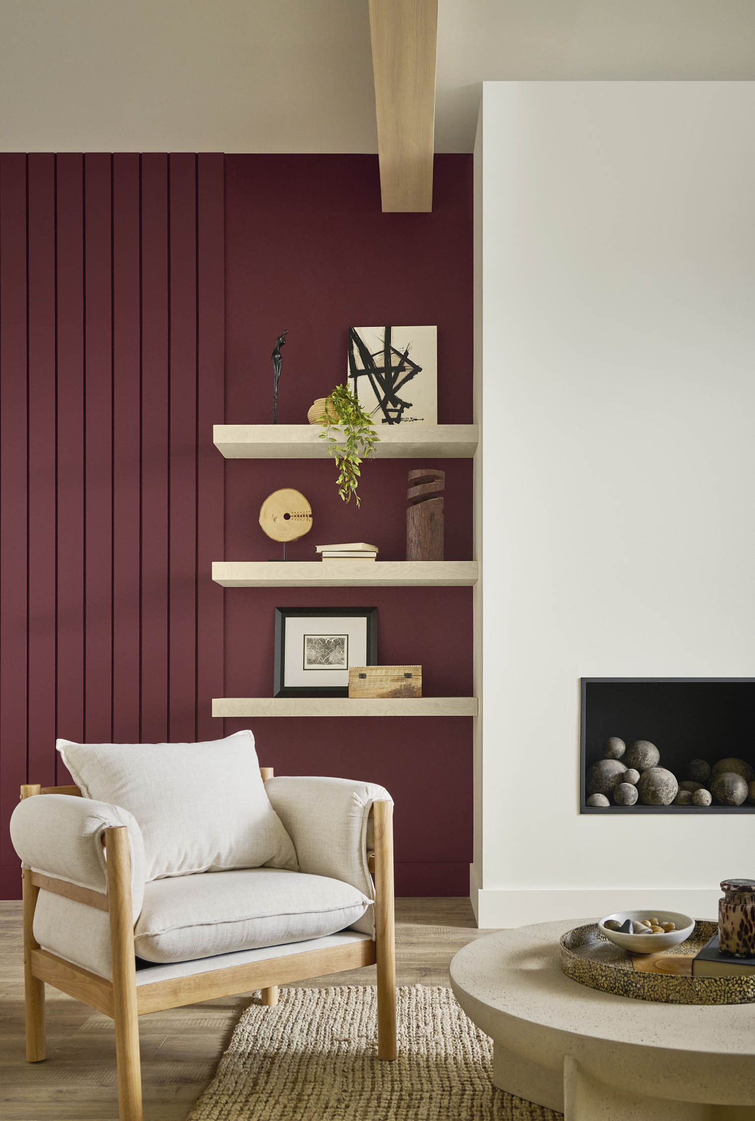 corner of living room with dark red walls and white fireplace