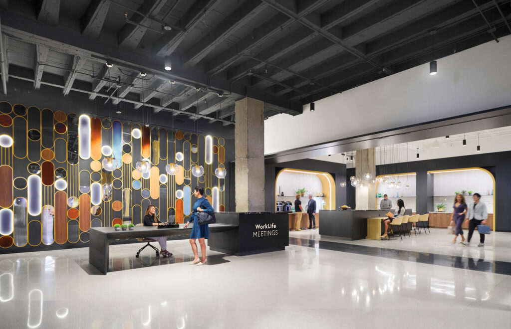 large reception area with black table, arches and colorful backdrop