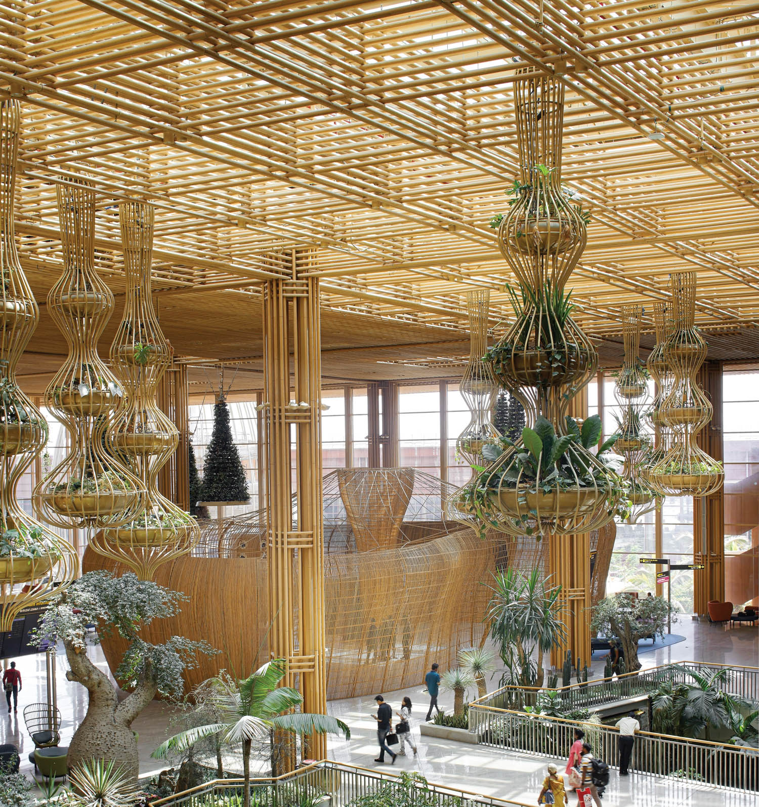 "terminal in a garden" with rattan pavilions, bamboo planters and olive trees