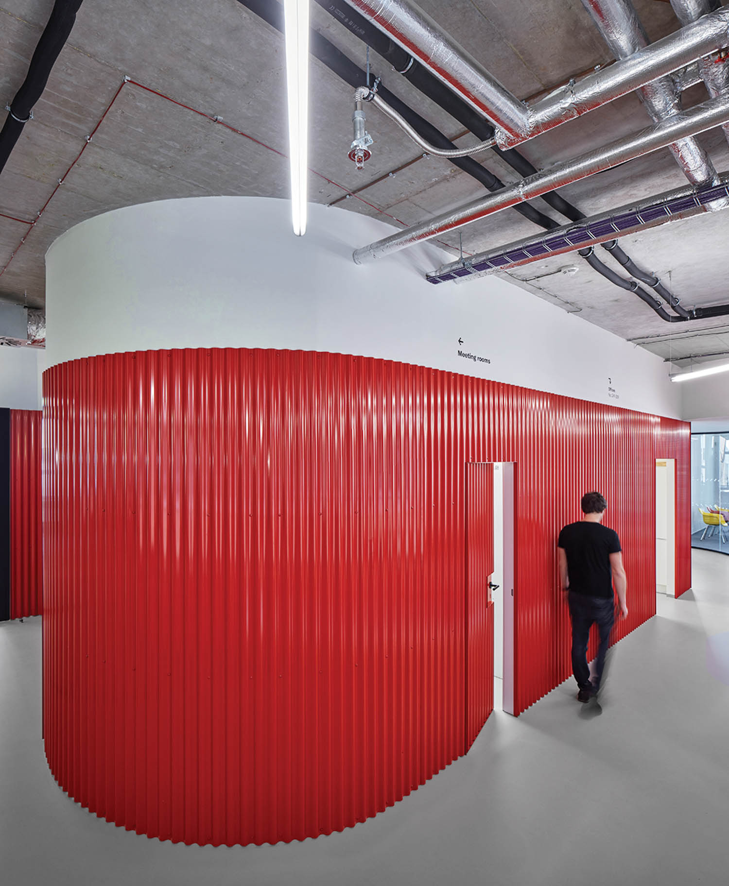 hallway with all red drapes that serve as a divider