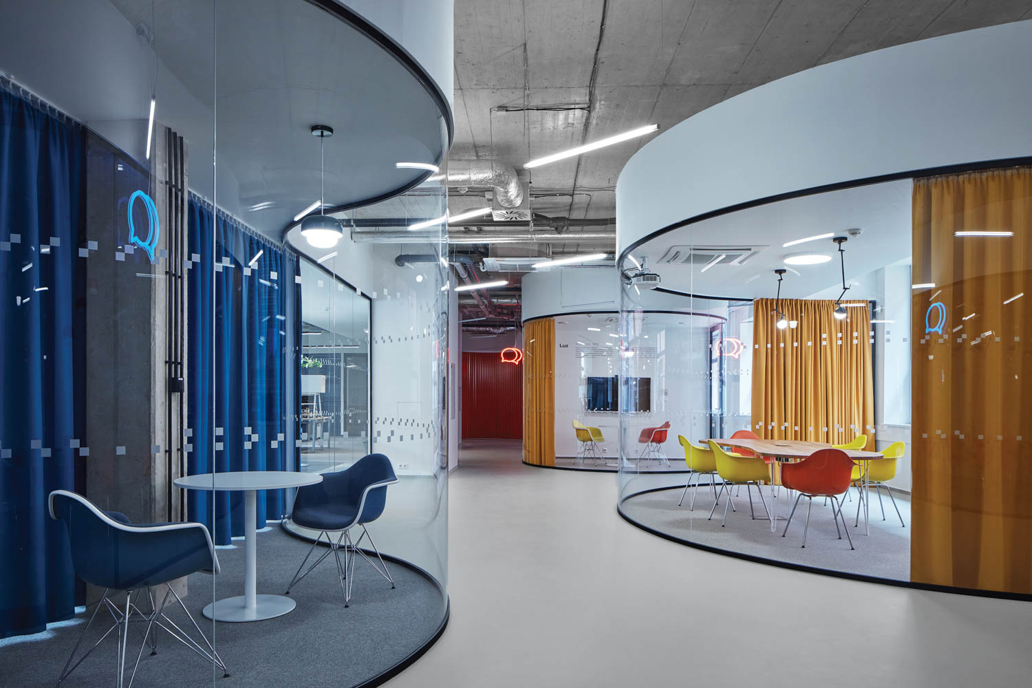 private booths with curved glass and colored drapes