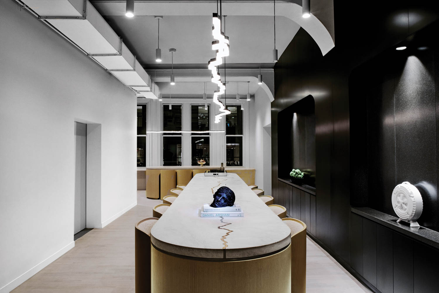 conference room with dark black wall, long marble table and black head centerpiece