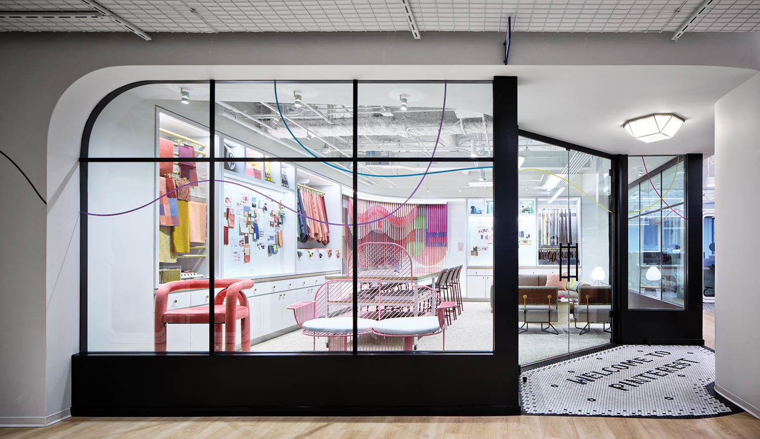 gallery area with furnishings, black frame windows and bright lights