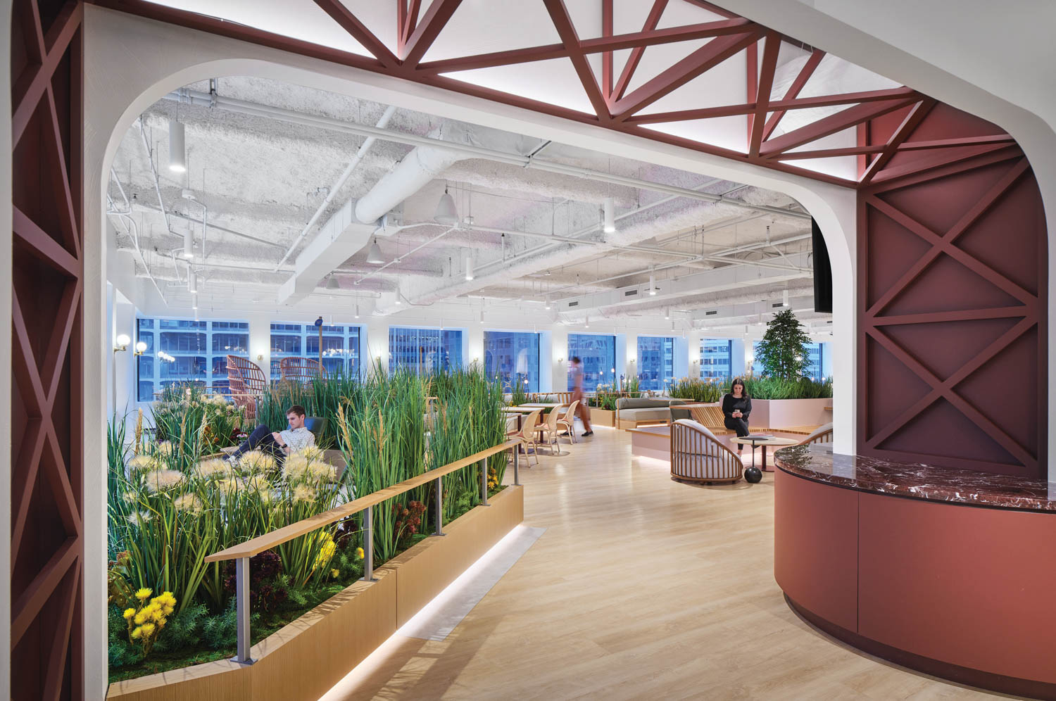 seating area with greenery, chairs and lots of beams and windows