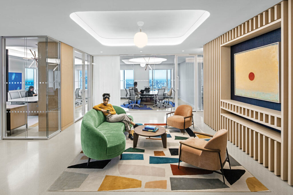 lounge with geometric rug, green sofa and view of the surrounding conference rooms