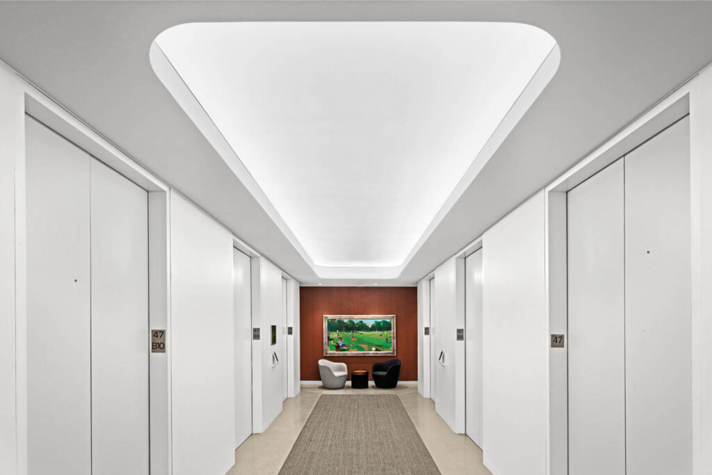 Elevator lobby with plaster-coated acoustic paneling