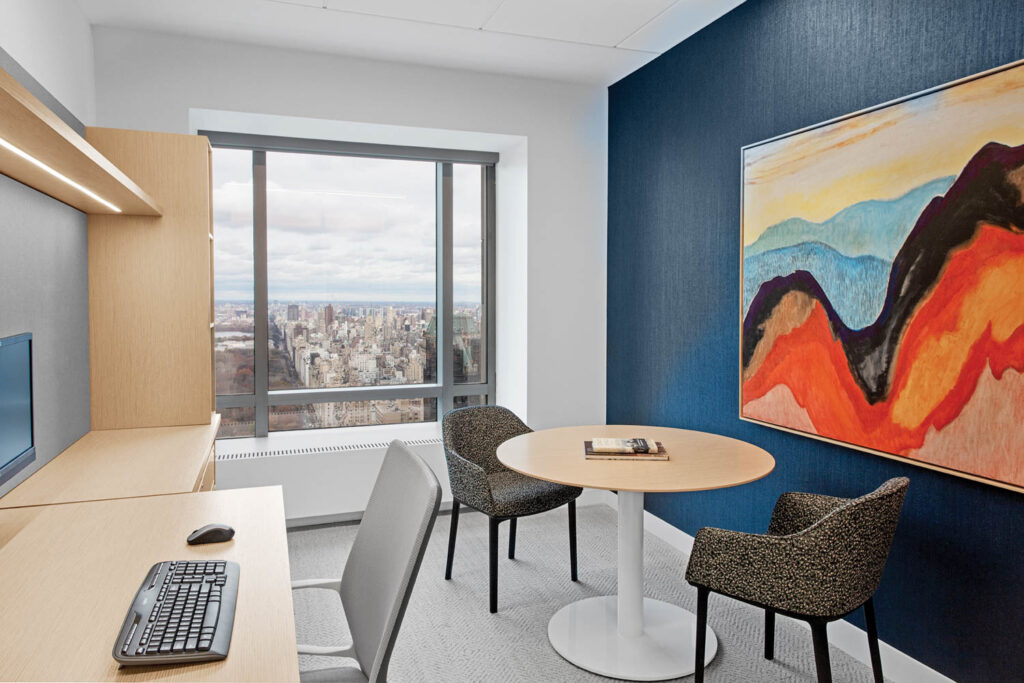 meeting room with white oak-topped table and workspace