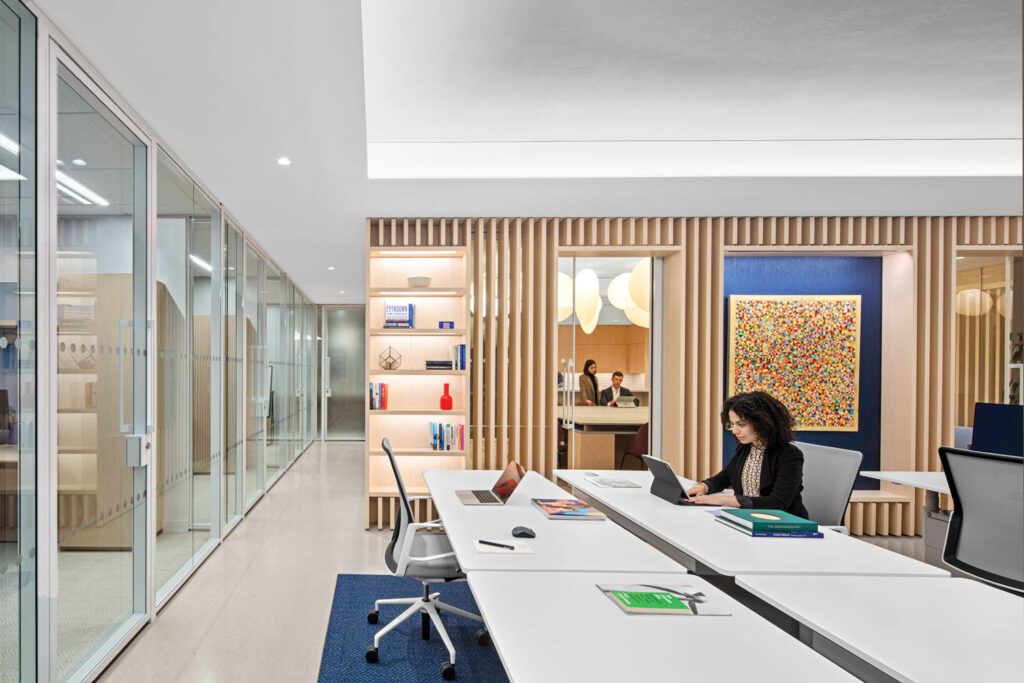 open office area with lots of seating and open shelving on the walls