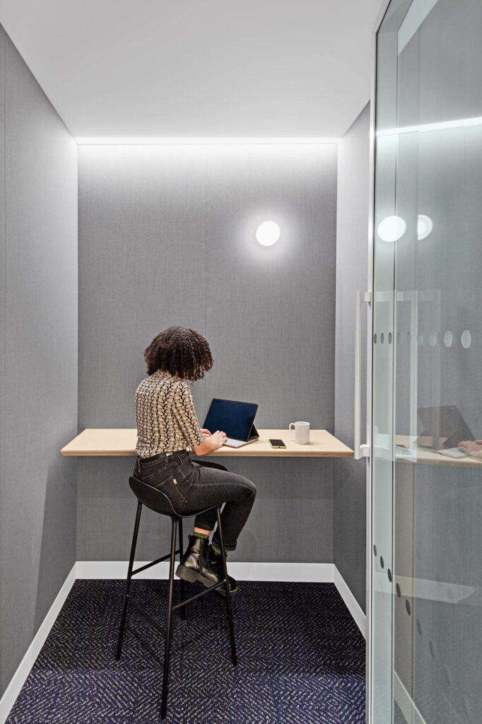 nook with grey walls, a dim sconce and a workspace