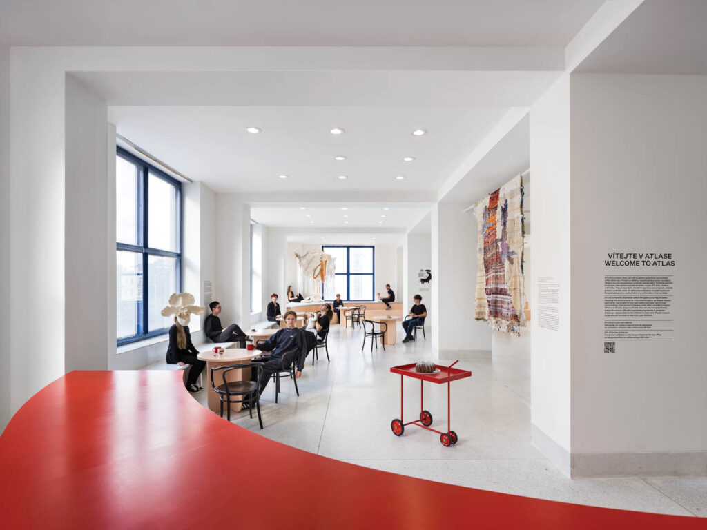 cafe with bright red tables, large windows and artwork everywhere