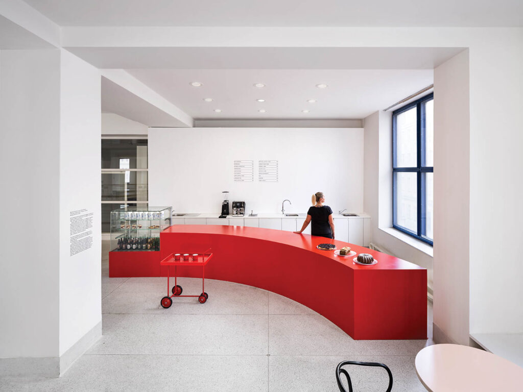 cafe with long curved red table and red tray