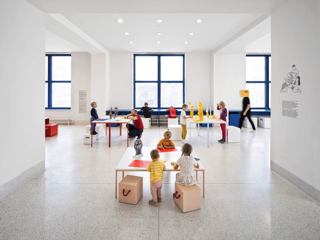 kids section with custom tables and large blue-framed windows