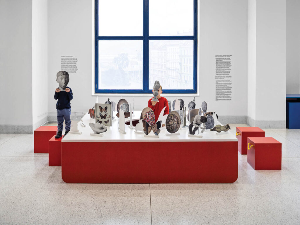 interactive installation with red platforms with miniature replicas