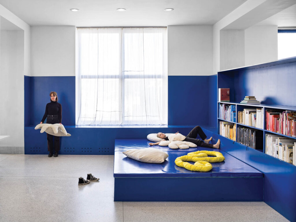 reading space with dark blue walls and lots of areas to relax