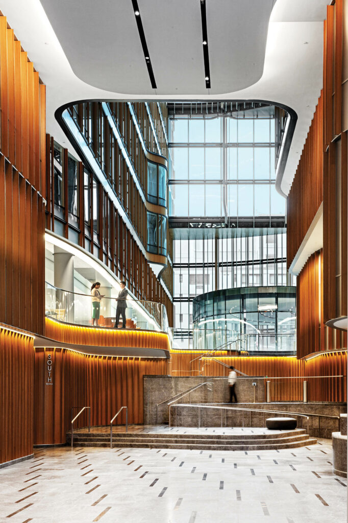 lobby with multiple floors, balconies and wooden panels