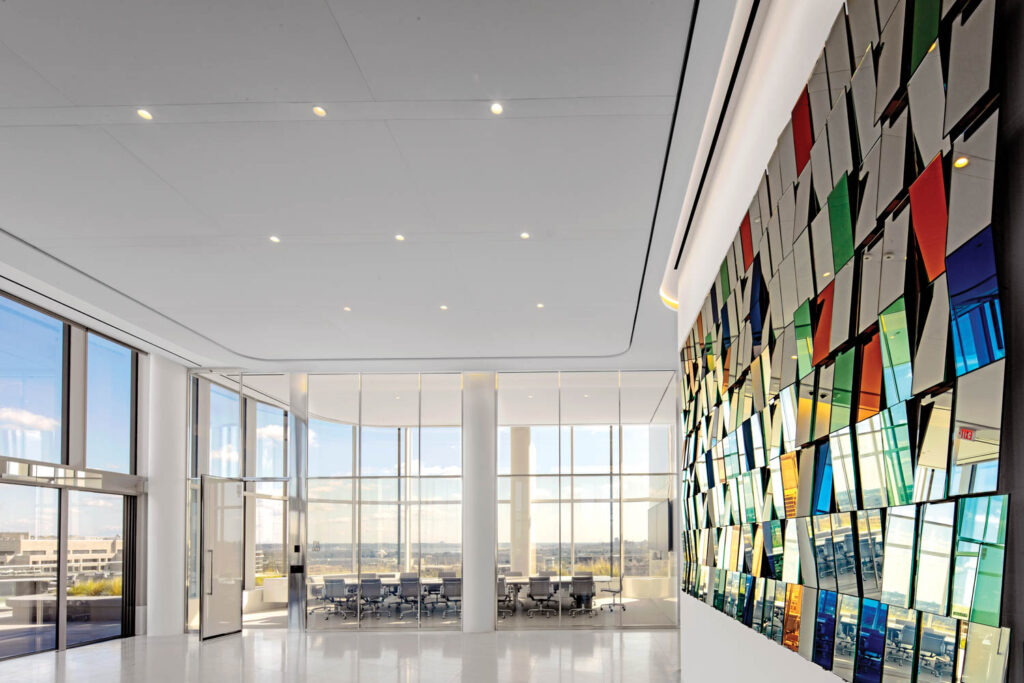 boardroom with view to the outside and outside is a hanging glass mirror walls sculpture