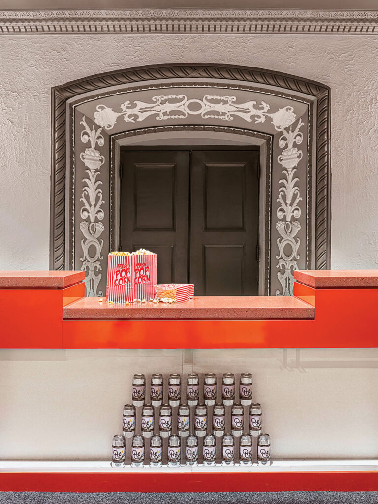 bar with red countertop and decorated door behind