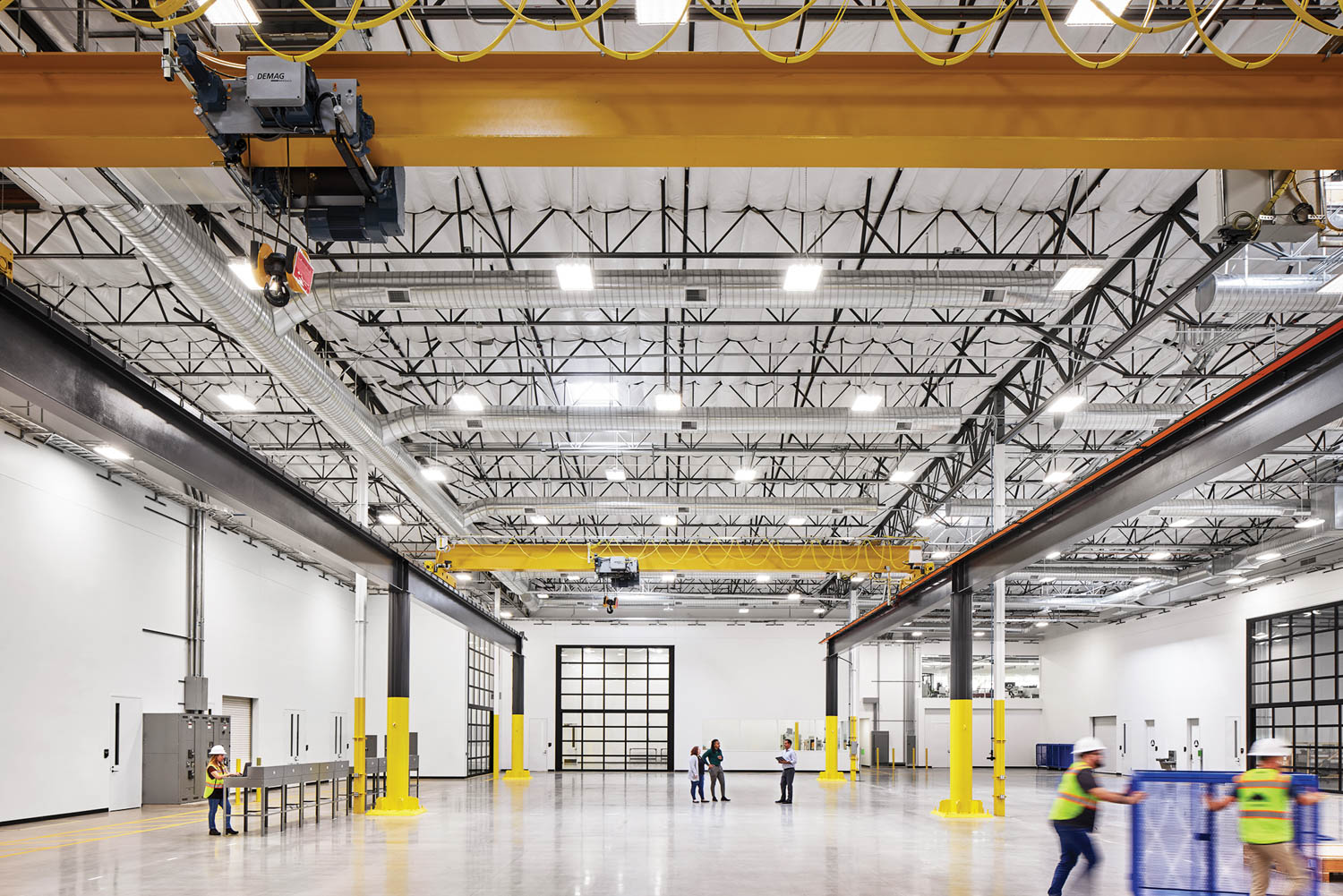 Assembly room and testing floor with bright fluorescent lights and steel beams