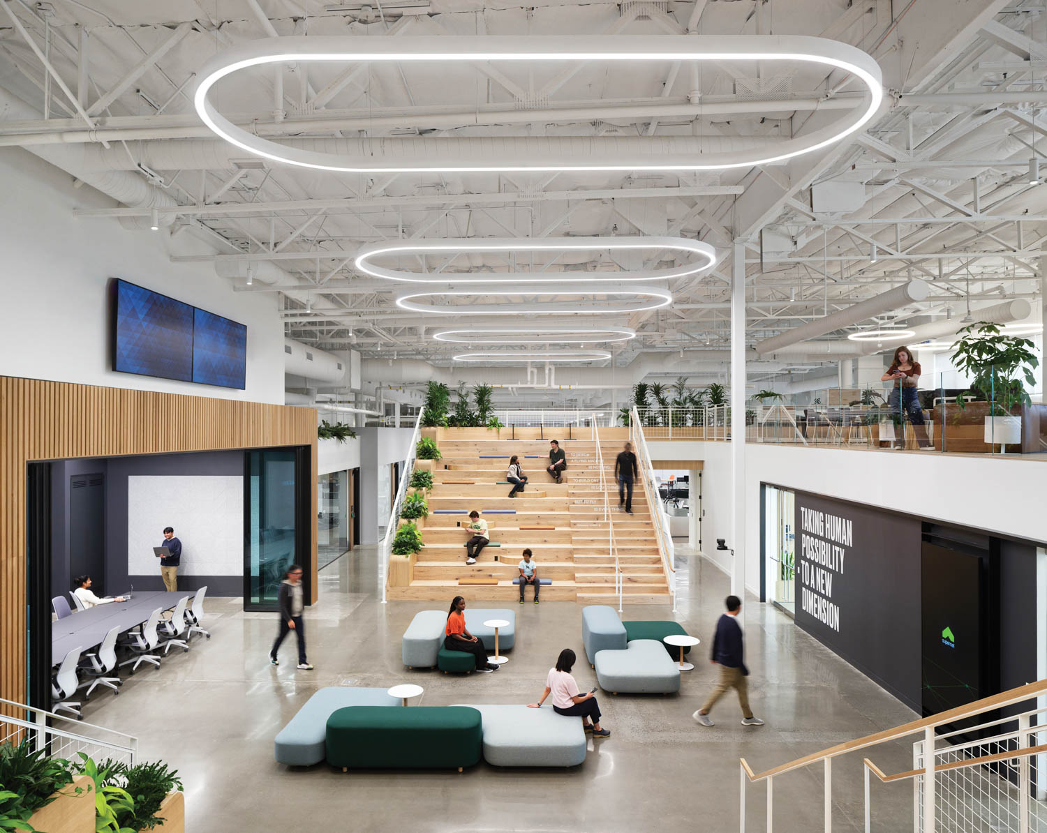 common seating area with white-oak bleachers, two-level mezzanine and stairs