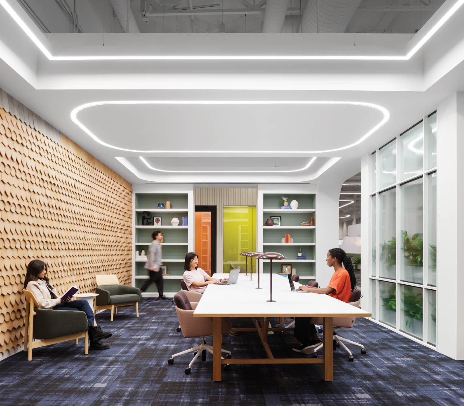 lounge chairs in the library in front of cork-tile covered walls