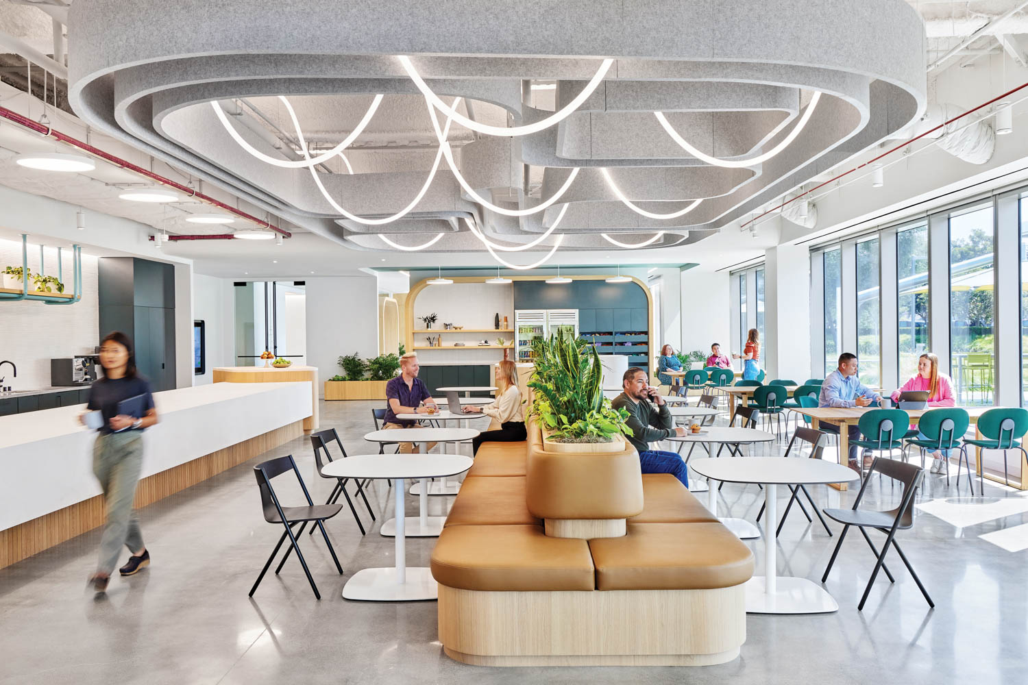 cafe area with lots of tables and seating and sculptural and LED ropes hanging from ceiling