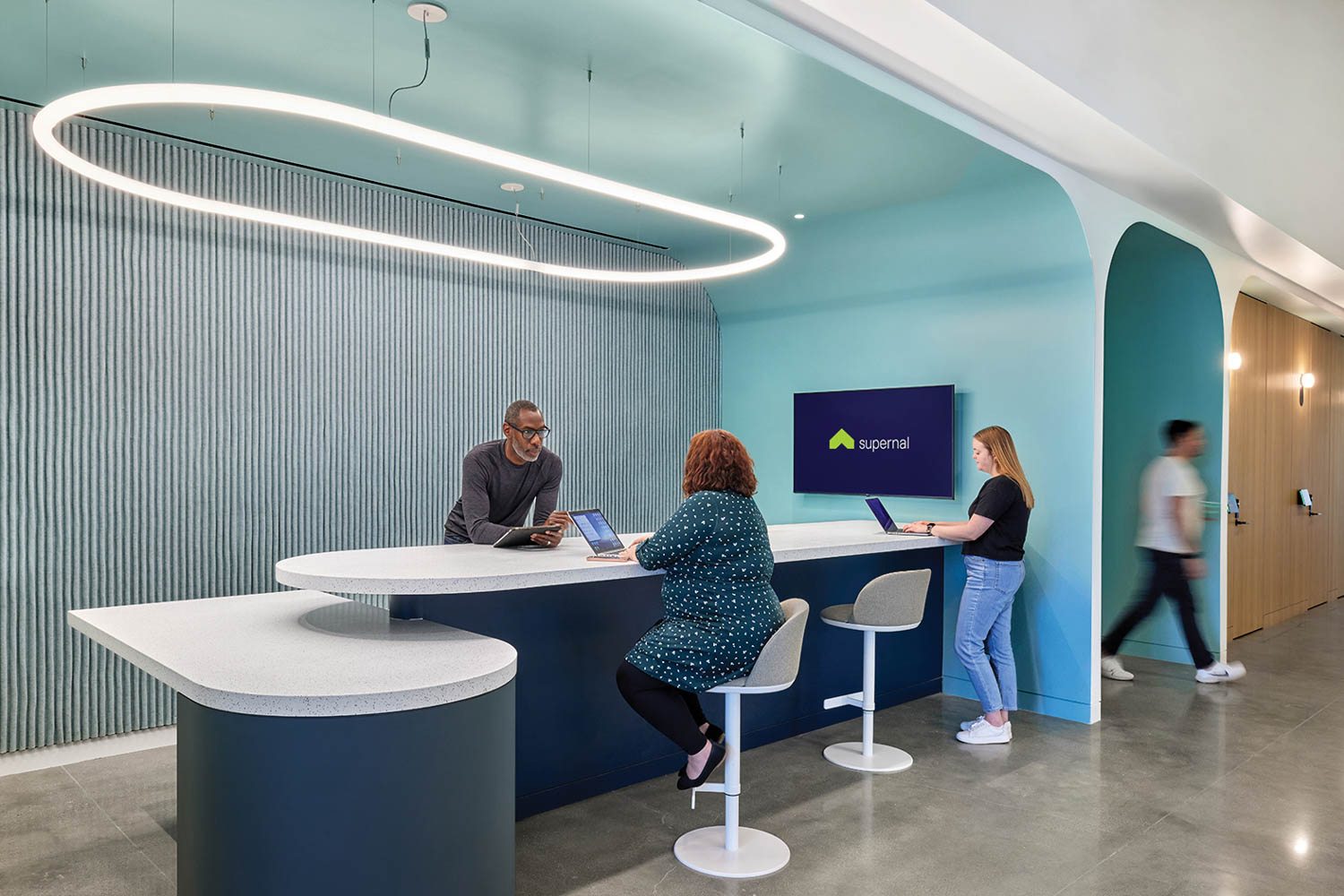 IT help desk area with blue walls, large light fixture and long desk