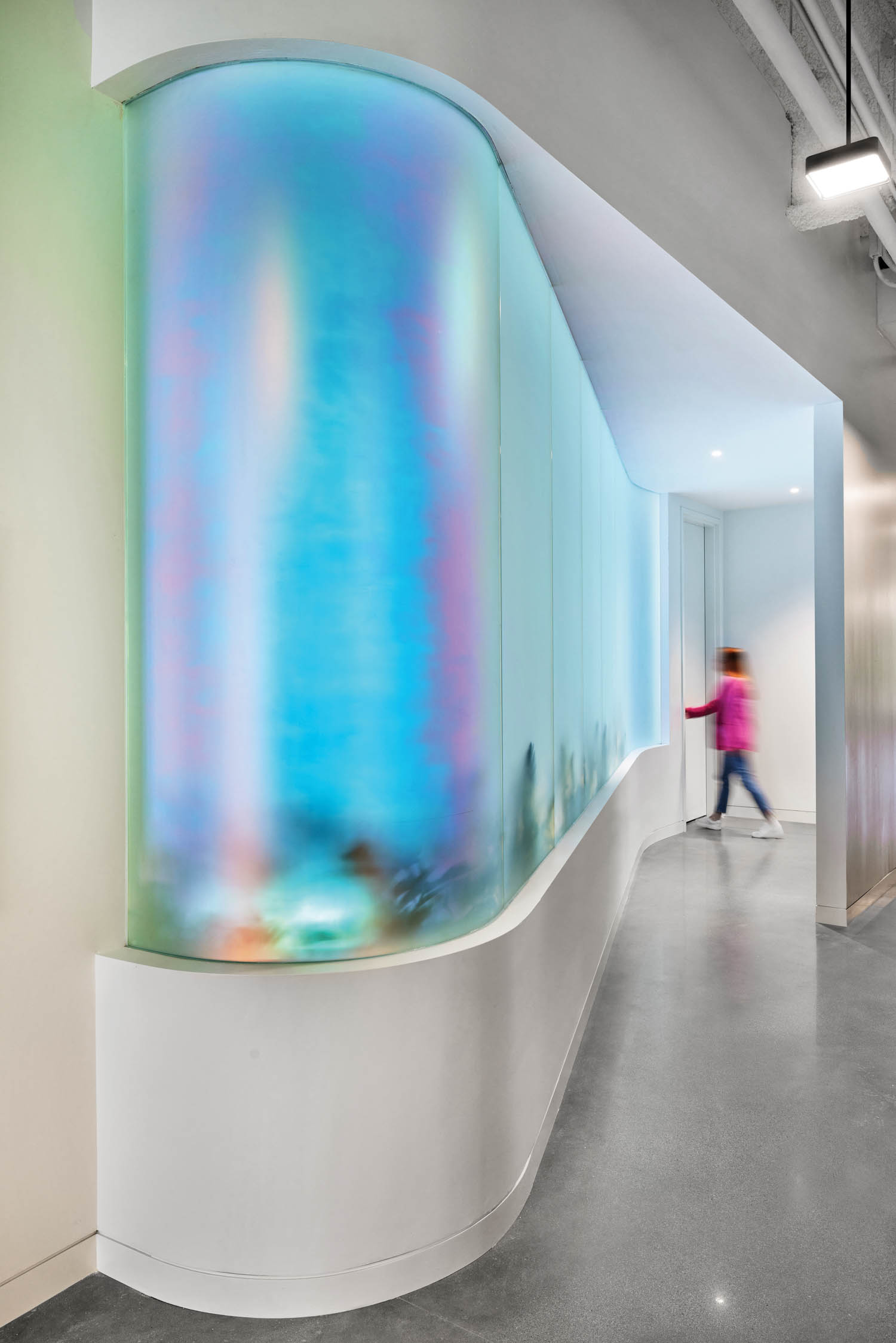 curved wall of iridescent glass, which is outside the sensory retreat room