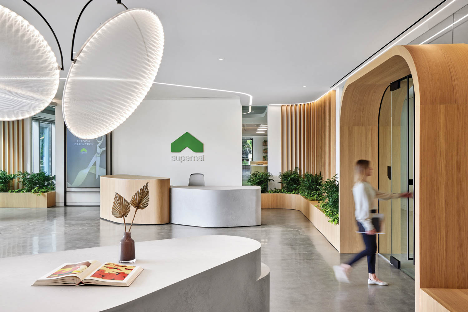 reception area in Supernal with bright lights, white reception desks and arched entryways