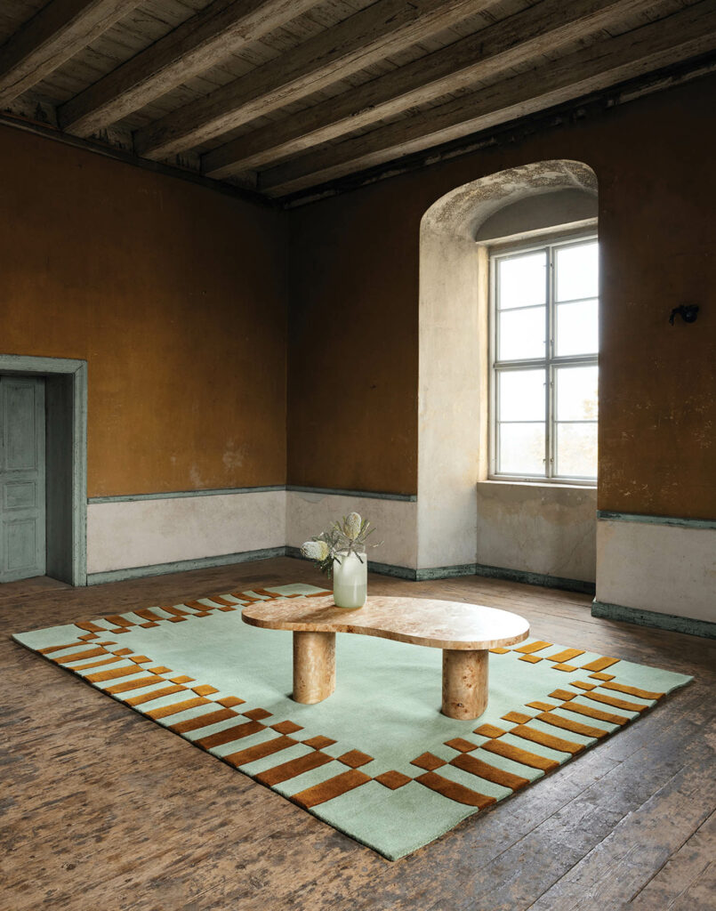 a room with the green frame wool rug