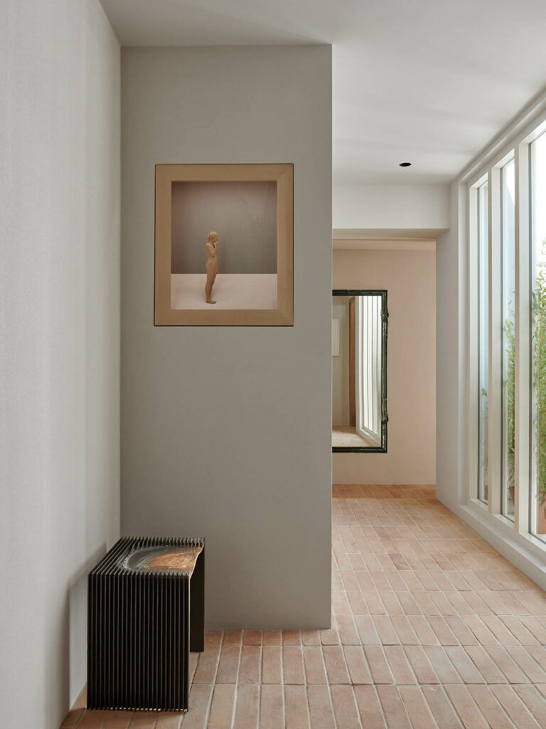 hallway with white walls and artwork