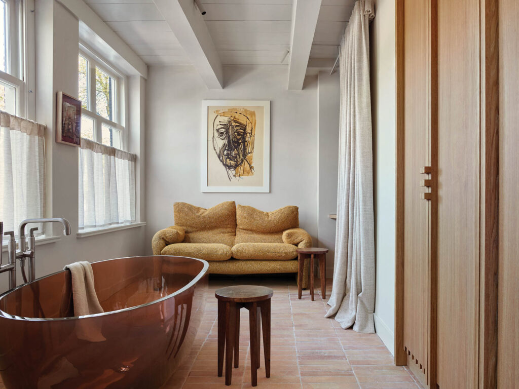 bathroom with copper tub and yellow couch