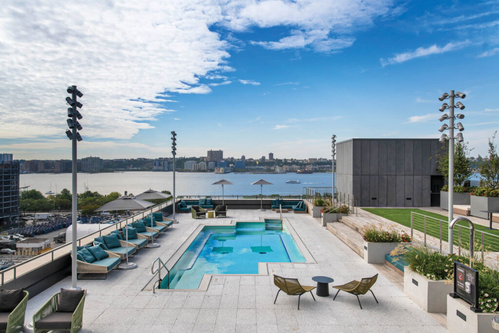 large pool with daybeds overlooking the Hudson River