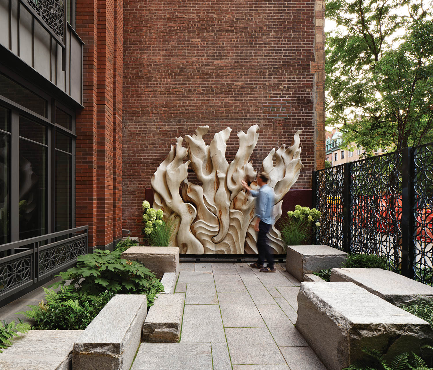 outdoor patio with large statue and benches