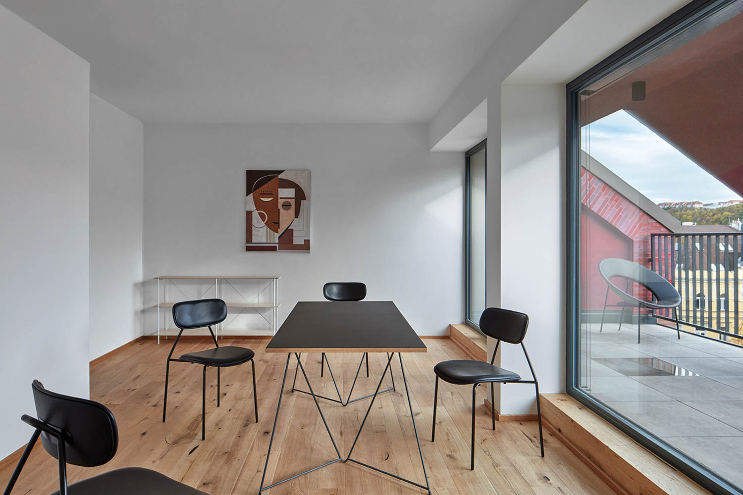 dining area with black chairs and table and artwork