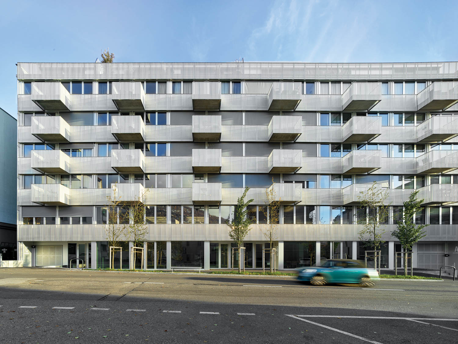 exterior facade of rental building with multiple balconies