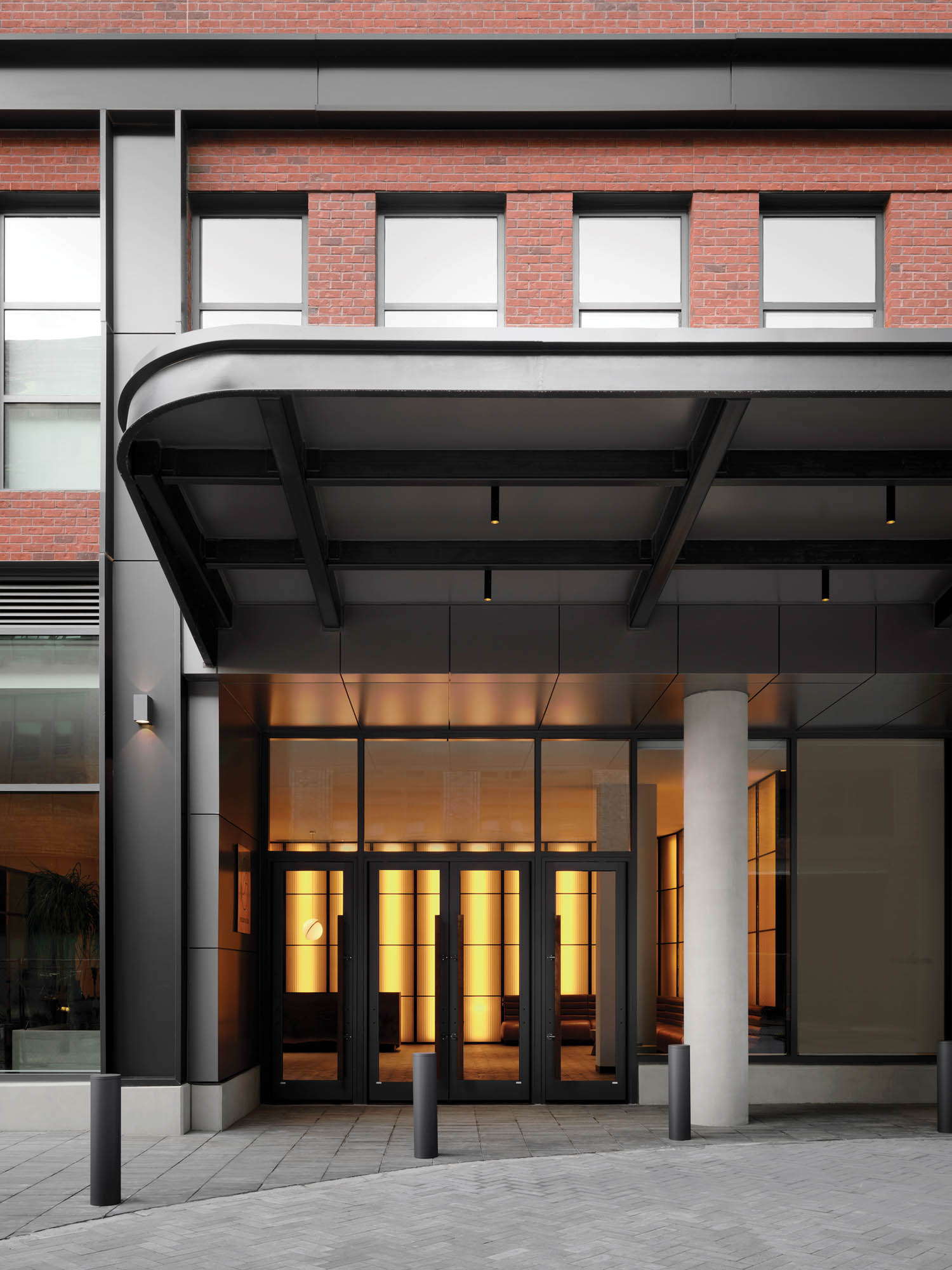 entrance of rental building with covered ceiling