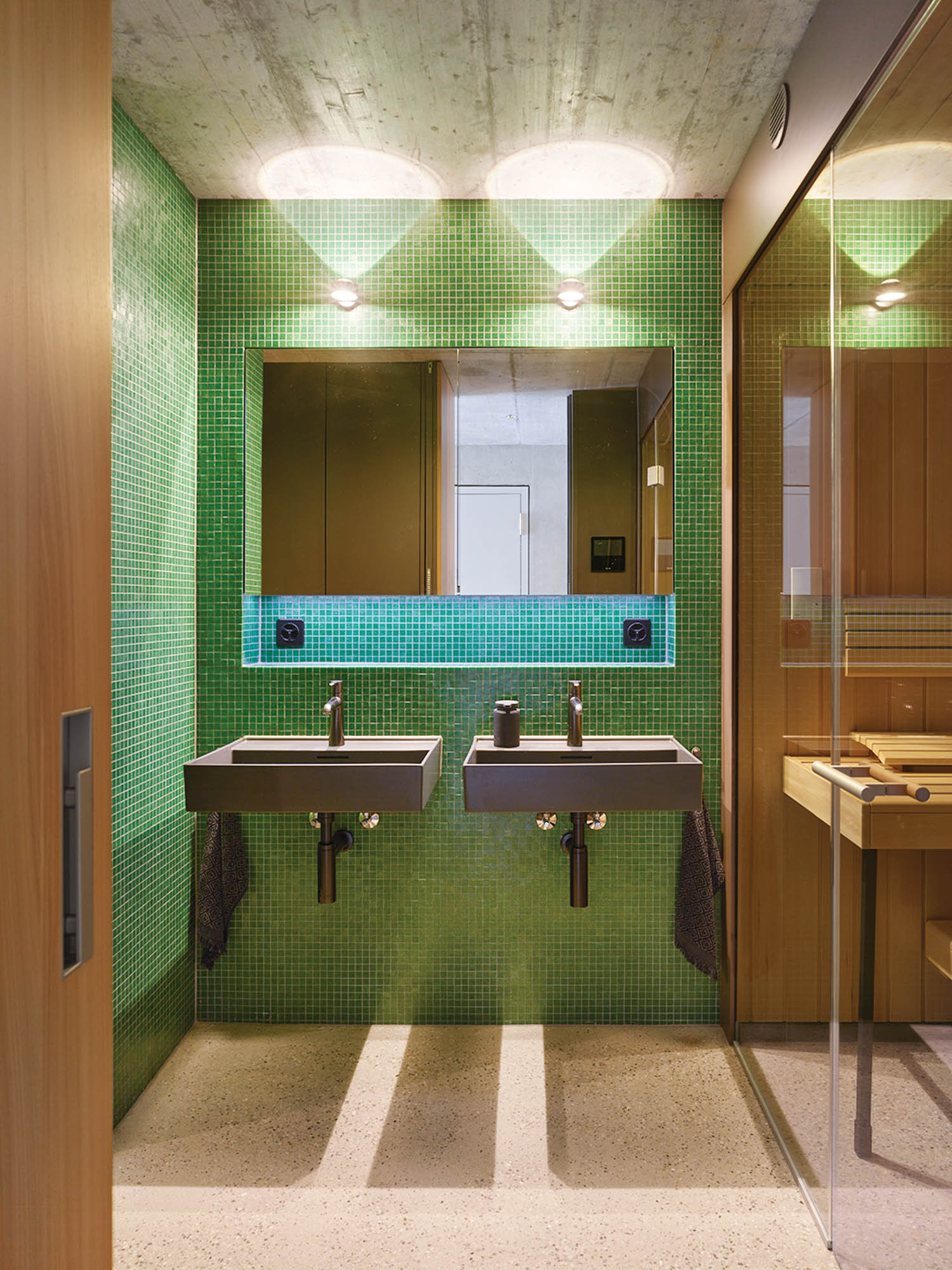 bathroom with green wallpaper, mirror and sinks