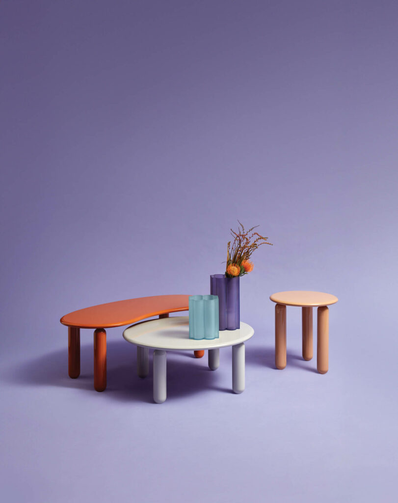 multiple colored tables against a lavender backdrop