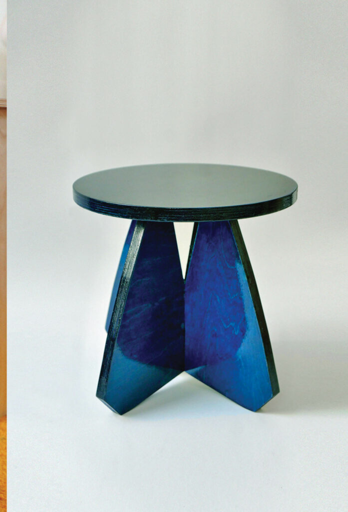 table with black tabletop and blue legs